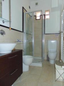 a bathroom with a shower and a toilet and a sink at Trilocale fronte mare a Marcelli - M210 in Marcelli