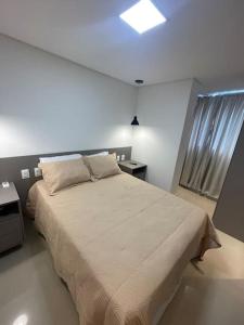a bedroom with a large bed and a window at Apartamento em João Pessoa (Miramar) in João Pessoa +11 photos