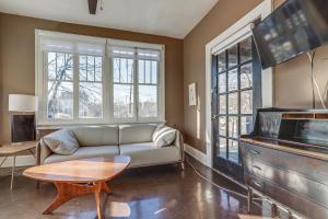 a living room with a couch and a table at Cozy Cincinnati Vacation Rental, Walk to Park! in Cincinnati