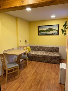 a living room with a couch and a table at Pension Švýcarský dům in Trutnov