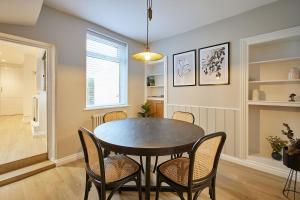 a dining room with a table and chairs at Host & Stay - Penny Farthing Cottage in Whitby
