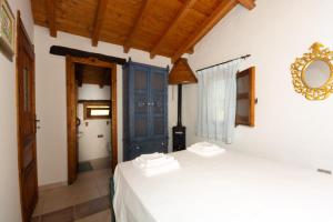 a room with two beds and a mirror on the wall at Villa L'Oliveto in Oliena