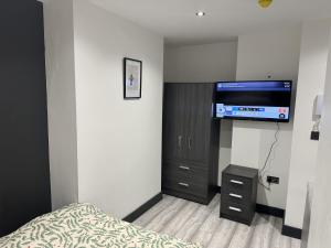 a bedroom with a bed and a flat screen tv at Impeccable 1-Bed Studio in London in London