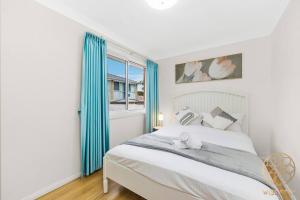 a bedroom with a bed with a teddy bear on it at Hurstville 2Br Granny flat near Shopping & Train in Sydney