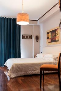 a bedroom with two beds and a pendant light at Affittacamere Le Dimore del Riccio in Foggia