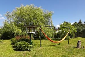 a playground with a hammock in a yard at "Haus Landgang" für Naturliebhaber, strandnah, ruhig, mit großem Garten in Pepelow