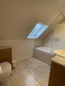 a bathroom with a toilet and a skylight at The Cottage, overlooking Loch Fyne in Cairndow