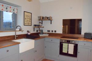 a kitchen with a sink and a counter top at Dairy in the Black Mountains in Abergavenny