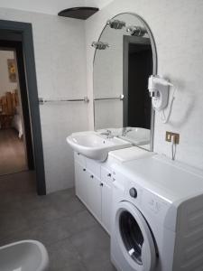 a bathroom with a sink and a washing machine at Ca' d'Luca in Ravenna