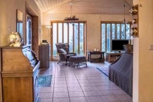 a living room with a couch and a tv at Ferienhaus Sonne Harz und Sterne in Hohegeiß