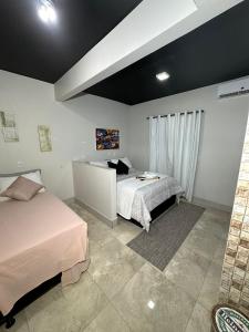 a bedroom with two beds and a table in it at Riacho HOTEL in Brasília