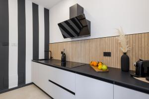 a kitchen with a counter with a bowl of fruit at Sunway Apartments in Alghero