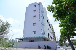 a hotel building with motorcycles parked in front of it at The One Hotel Nashik in Nashik