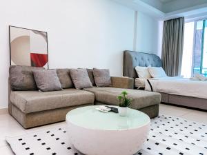 a living room with a couch and a coffee table at Cozy living studio , with private balcony @ Mont Kiara Hartamas in Kuala Lumpur