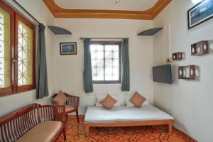 a living room with a couch and a window at Villa Seafront Goa in Anjuna