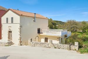 a large white house with a balcony on it at La Maison to Chani in Stílos