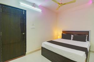 a bedroom with a bed and a black door at Super Collection O Hotel Mayur Inn in Hyderabad
