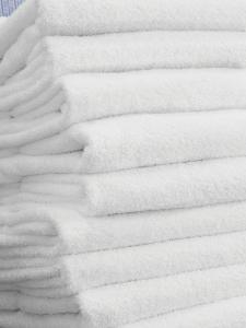 a pile of white towels on a bed at Fairfield Inn & Suites by Marriott Savannah Downtown/Historic District in Savannah