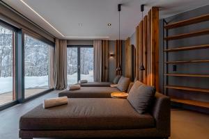 a living room with two couches and a large window at Chalet VIE in Viehhofen +40 photos