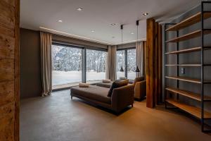 a living room with a couch and a large window at Chalet VIE in Viehhofen