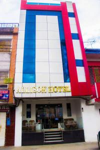 ein rotes, weißes und blaues Gebäude mit einem Hotel in der Unterkunft ALLISON HOTEL in Iquitos
