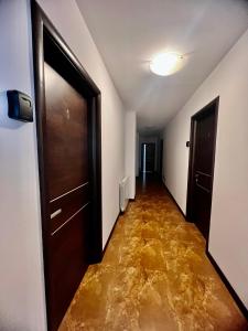 um corredor vazio com uma porta e um piso de água em 4 Room Rental Unit em Marginea