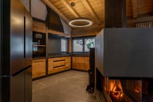 a kitchen with a fireplace in the middle of it at Chalet VIE in Viehhofen