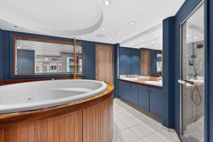 a bathroom with a large tub and two sinks at Large 41 millions kr Apartment - seaview in center in Oslo +43 photos