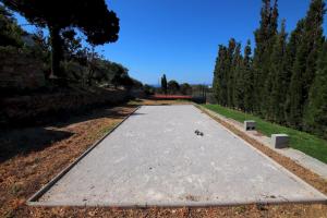 a walkway in the middle of a park with trees at Villa Mahé Tennis Karystos island EVIA in Karistos