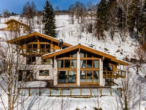 a log home in the snow with snow at Chalet VIE in Viehhofen