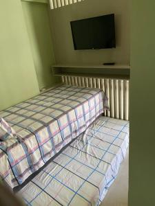 Uma cama ou camas num quarto em Quarto e Sala Beira Mar Maceió