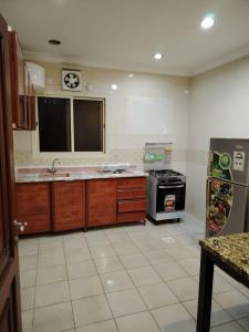 a kitchen with a sink and a stove at العالية للشقق المفروشه الشهري in Jeddah