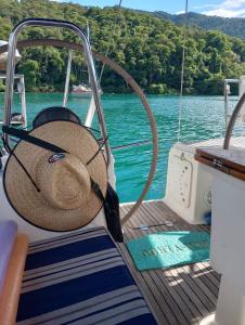 a straw hat sitting on the deck of a boat at Paseos en Velero en Angra dos Reis in Angra dos Reis