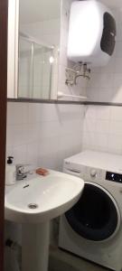a bathroom with a sink and a washing machine at Apartamento Happyness Complex Amaya Fuerteventura in Costa de Antigua