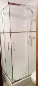 a bathroom with a glass shower with a toilet at Apartamento Happyness Complex Amaya Fuerteventura in Costa de Antigua