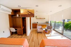 a bedroom with a living room and a kitchen at KUKO SUITES in Chilpancingo de los Bravos