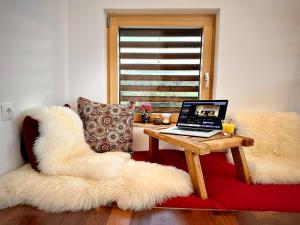 a laptop computer sitting on a couch with a table at Das Rizzi in Grössing
