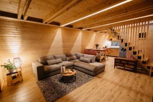 a living room with a couch and a table at Azalea Chalet in Divčibare