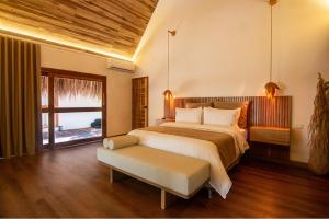 a bedroom with a large bed and a window at Tewimake Hotel in Santa Marta