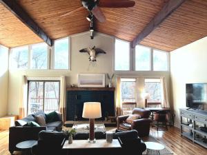a living room with a ceiling fan and a cow head on the wall at LUX Popular Lakefront, Close to Ski, Snowboard, Games in Bushkill