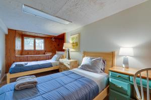 a bedroom with two beds and a desk with two lamps at LUX Popular Lakefront, Close to Ski, Snowboard, Games in Bushkill