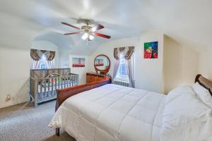 a bedroom with a crib and a ceiling fan at Mount Vernon Getaway - 4 Mi to the Bronx Zoo! in New Rochelle