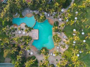 an aerial view of a resort pool with palm trees at Taj Exotica Resort & Spa, Goa in Benaulim