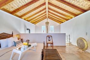 a living room with a couch and a table at La Maison to Chani in Stílos