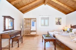 a living room with a piano and a couch at La Maison to Chani in Stílos