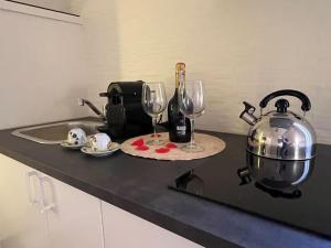 a kitchen counter with a tea kettle and wine glasses at Apartment with hydromassage Piazza del Popolo in Rome