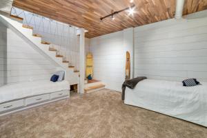 a bedroom with a staircase and a bed and a surfboard at Waterfront Home Allegheny River Access, Dock Slip in Ford City