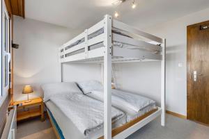 a white bunk bed in a white bedroom at Alexandra 21 - 4 pers - pres des pistes in Nendaz