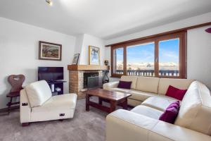 a living room with a couch and a fireplace at Arnica 1 - 6 pers - piscine in Nendaz