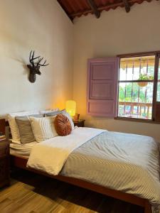 Ένα ή περισσότερα κρεβάτια σε δωμάτιο στο LA HERMOSA CASA AMARILLA